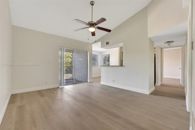 unfurnished living room with high vaulted ceiling, light hardwood / wood-style flooring, and ceiling fan