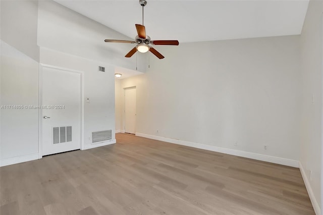 spare room featuring light hardwood / wood-style floors, ceiling fan, and lofted ceiling