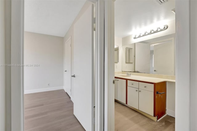 bathroom with vanity and wood-type flooring