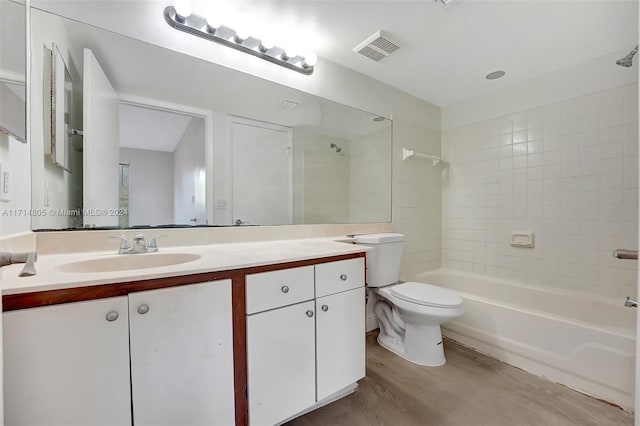 full bathroom with wood-type flooring, vanity, toilet, and tiled shower / bath