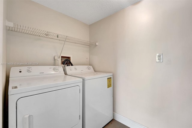 laundry area featuring separate washer and dryer and a textured ceiling