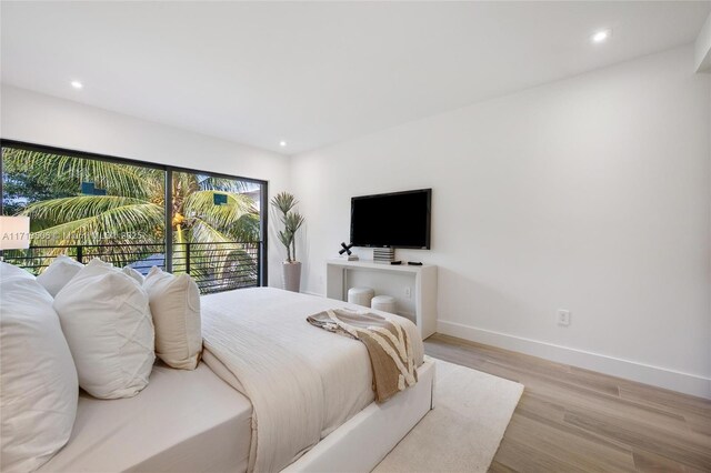 bedroom featuring light hardwood / wood-style floors and access to outside