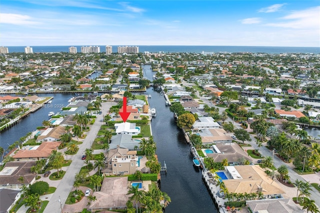 drone / aerial view featuring a water view and a residential view