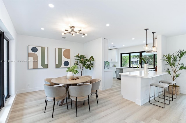 dining area featuring an inviting chandelier and light wood-type flooring