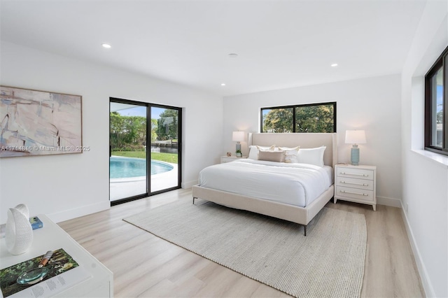 bedroom with access to outside, multiple windows, and light hardwood / wood-style flooring