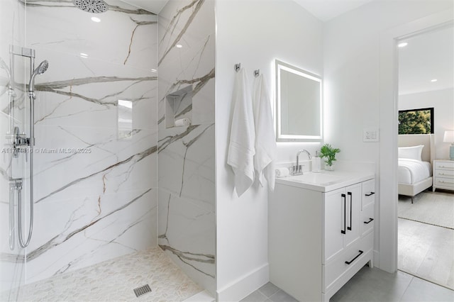 bathroom with tile patterned floors, vanity, and a tile shower