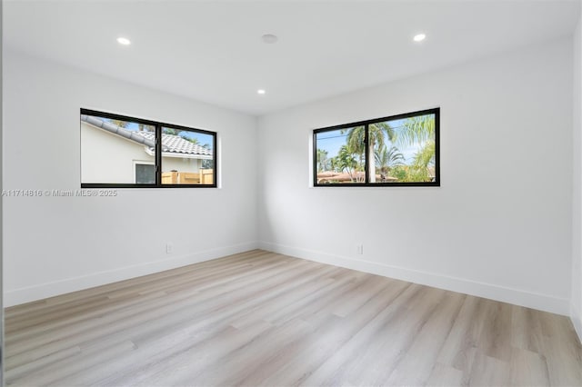 empty room with light hardwood / wood-style flooring