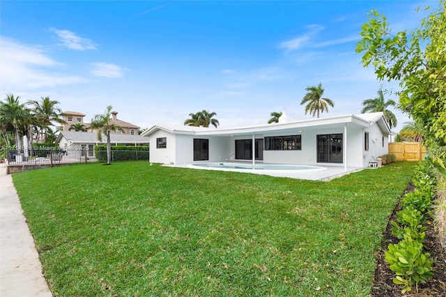 rear view of property with a patio area and a lawn