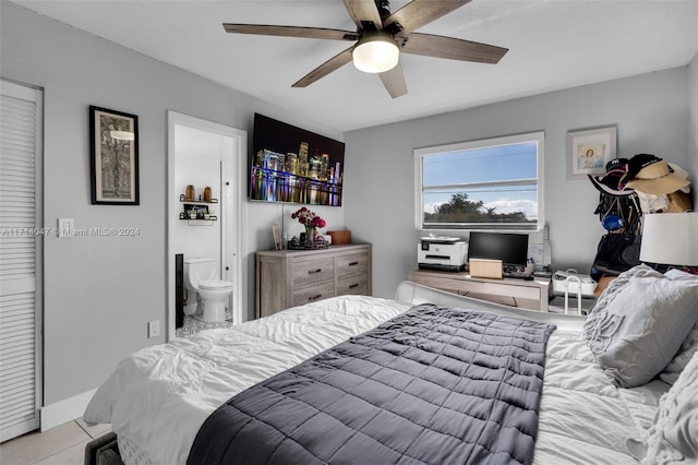 tiled bedroom with connected bathroom and ceiling fan