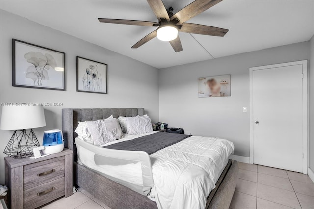 tiled bedroom featuring ceiling fan