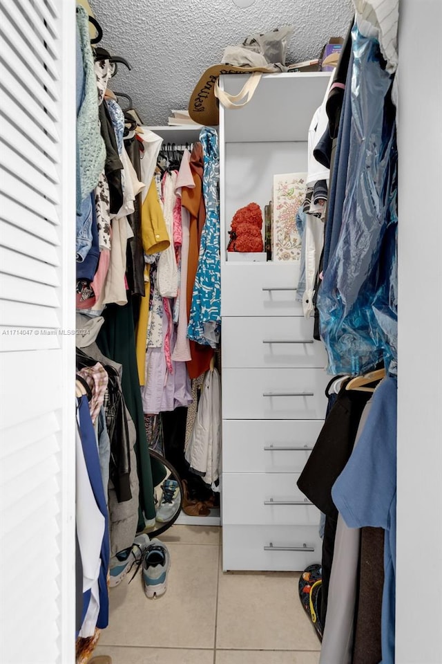 spacious closet with light tile patterned floors