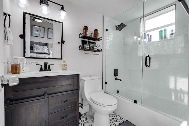 full bathroom featuring shower / bath combination with glass door, vanity, and toilet