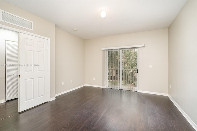 empty room with dark wood-type flooring