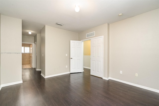 empty room featuring dark hardwood / wood-style flooring