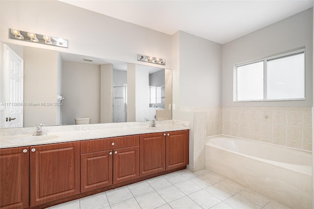 full bathroom featuring tile patterned flooring, vanity, independent shower and bath, and toilet