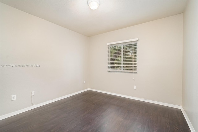 spare room featuring dark wood-type flooring