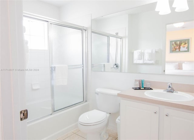 full bathroom with tile patterned floors, vanity, toilet, and enclosed tub / shower combo