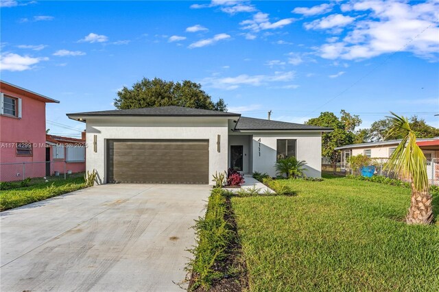 view of front of house with a front lawn and a garage