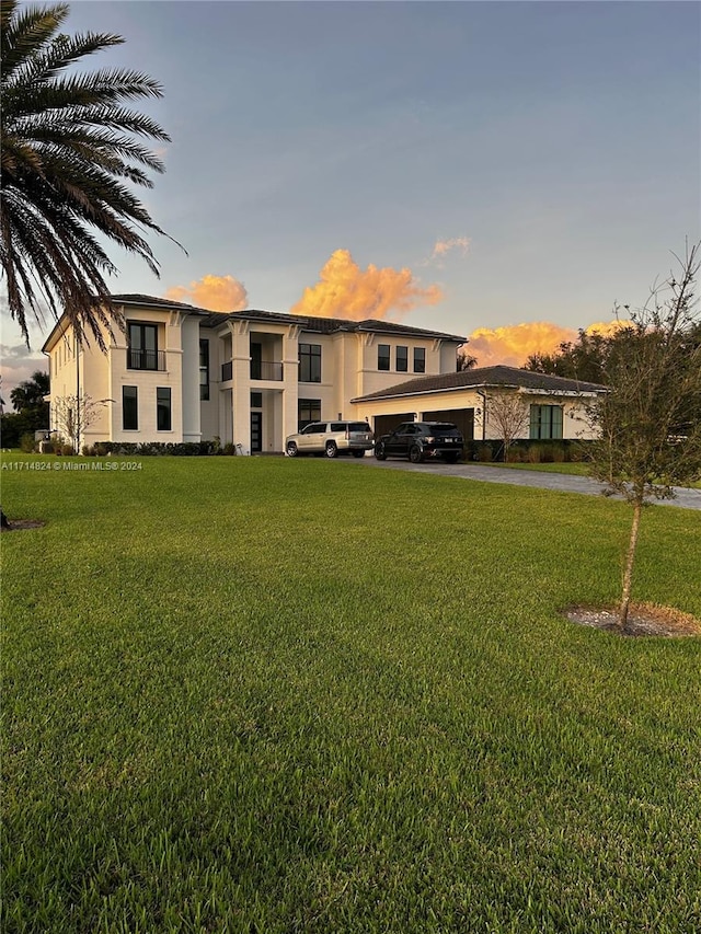 view of front of home with a garage and a yard