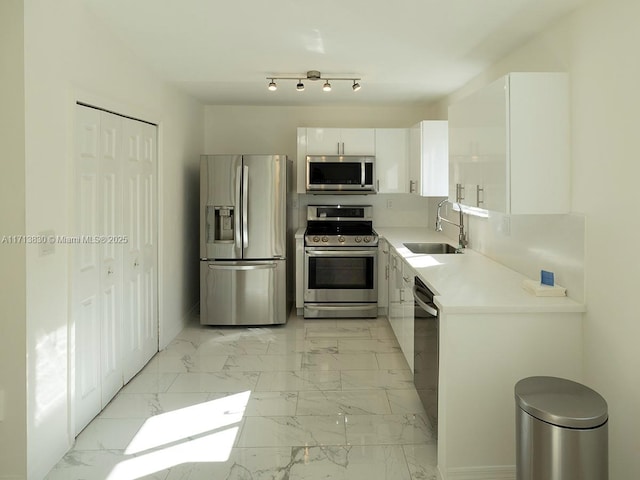 kitchen featuring white cabinets, sink, and stainless steel appliances