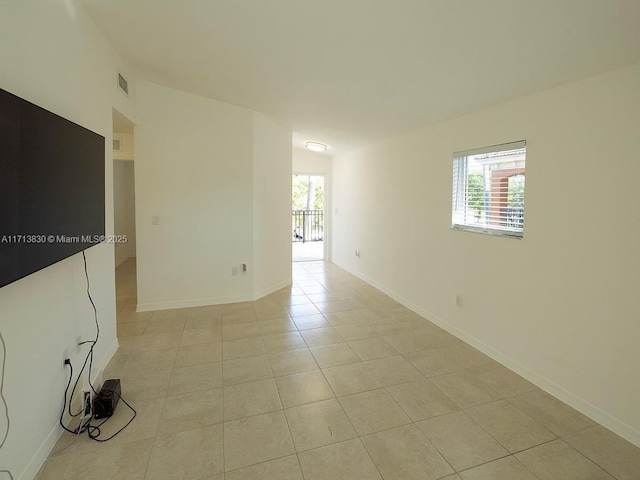 unfurnished room with light tile patterned flooring