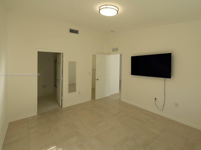 unfurnished room with a towering ceiling