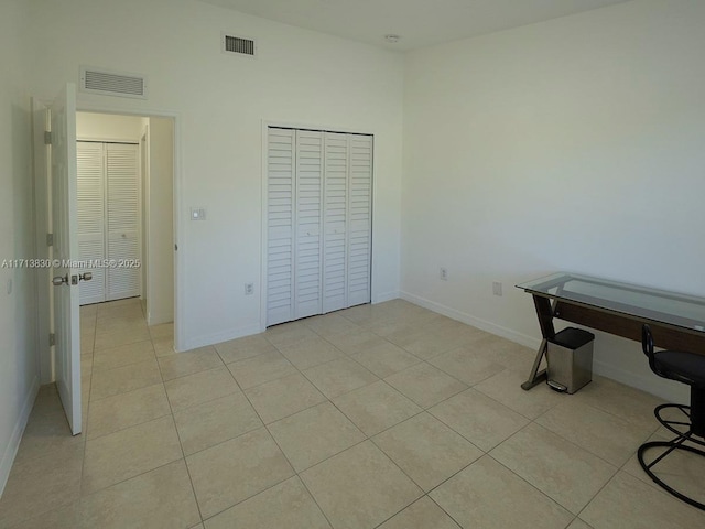 tiled bedroom featuring a closet