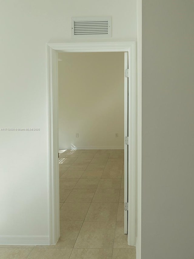 hall featuring light tile patterned floors