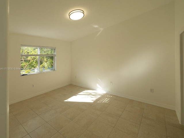 spare room featuring light tile patterned flooring