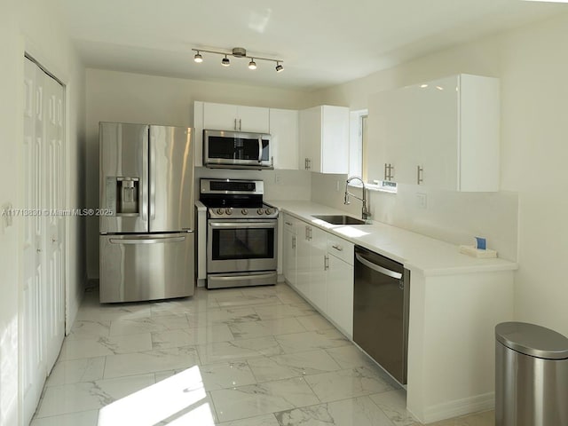 kitchen with white cabinets, sink, and stainless steel appliances