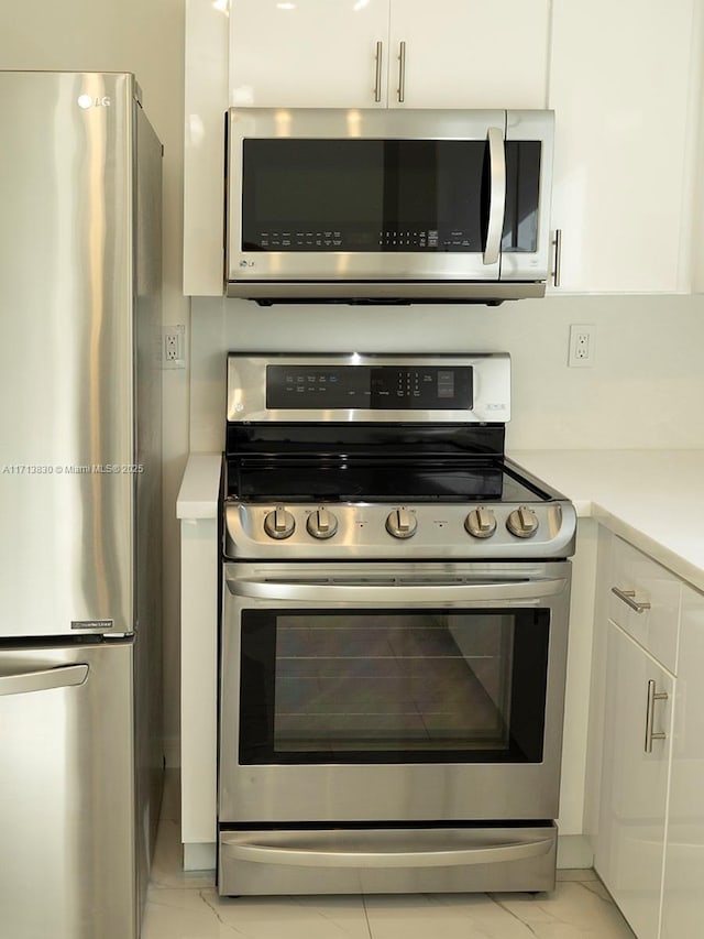 kitchen featuring appliances with stainless steel finishes and white cabinets