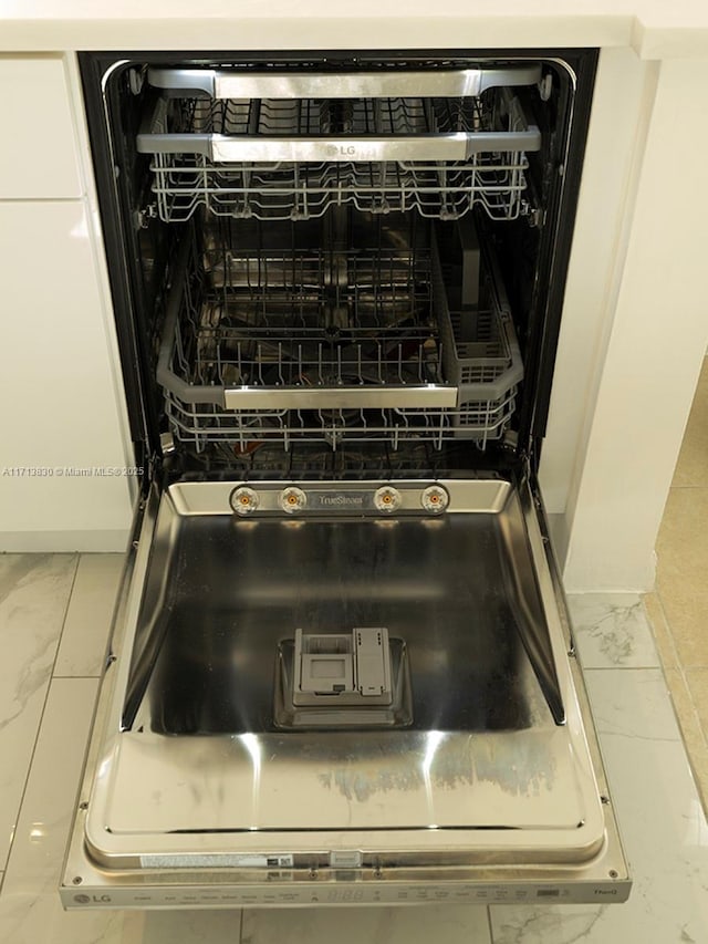 interior details featuring white cabinets and dishwashing machine