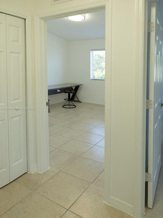 hall featuring light tile patterned floors