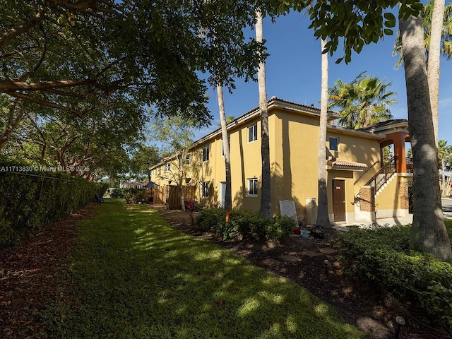 view of side of home featuring a lawn