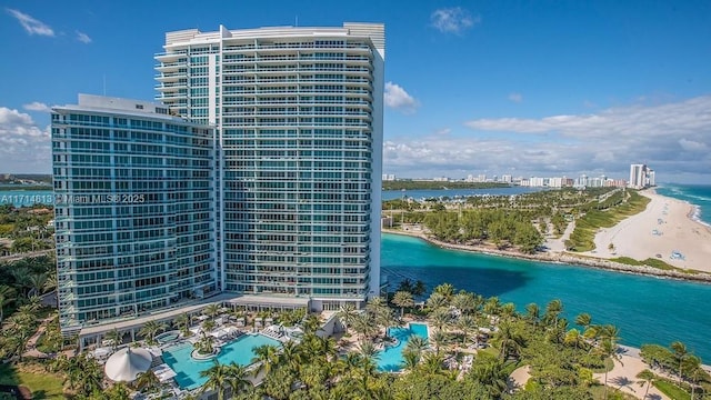 exterior space featuring a view of city, a beach view, and a water view