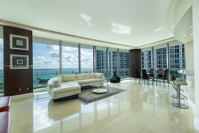 tiled living room with a water view and a wall of windows