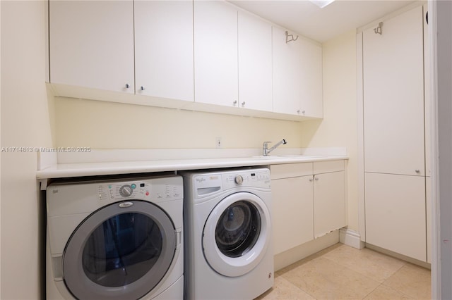 clothes washing area with cabinet space, independent washer and dryer, a sink, and light tile patterned flooring