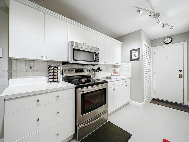 kitchen with white cabinets, stainless steel appliances, and tasteful backsplash