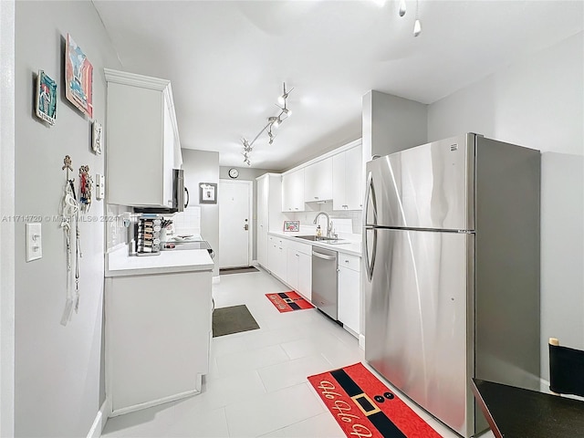 kitchen featuring white cabinets, stainless steel appliances, tasteful backsplash, and sink