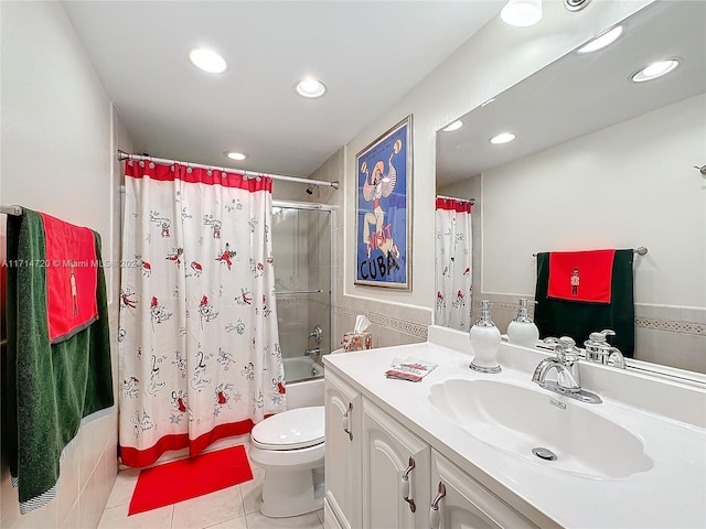 full bathroom with vanity, tile patterned flooring, toilet, shower / bathtub combination with curtain, and tile walls