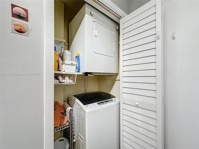 laundry area with stacked washer / dryer