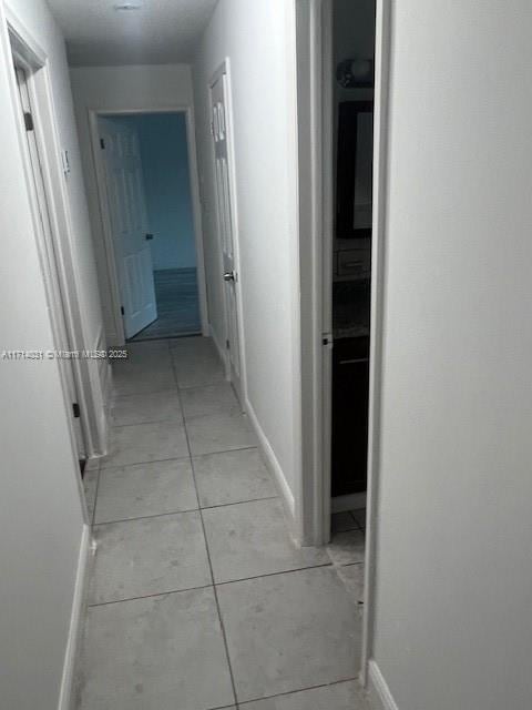 corridor featuring light tile patterned floors