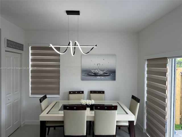 tiled dining space with an inviting chandelier