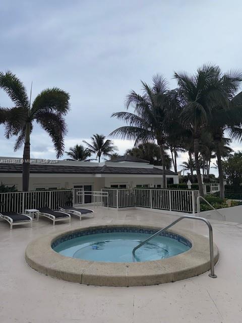 view of swimming pool featuring a hot tub