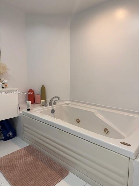 bathroom featuring tile patterned flooring and a washtub