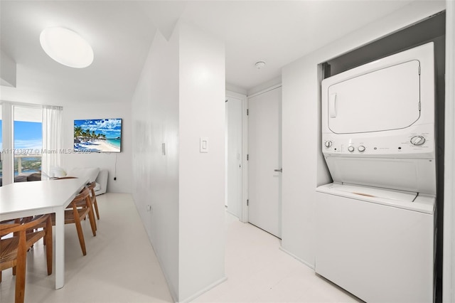 4779 Collins Ave Unit 3108, Miami Beach, FL 33140 - laundry area with estacked washer and dryer and baseboards