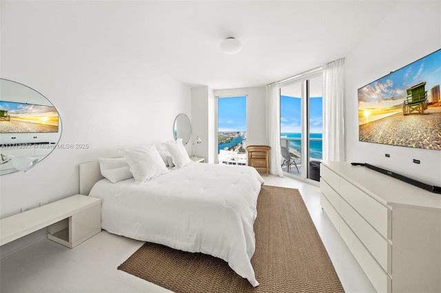 4779 Collins Ave Unit 3108, Miami Beach, FL 33140 - bedroom featuring access to outside, expansive windows, and light tile patterned flooring