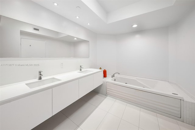 4779 Collins Ave Unit 3108, Miami Beach, FL 33140 - bathroom featuring a tub with jets, recessed lighting, double vanity, and tile patterned flooring