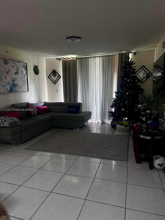 tiled living room featuring a textured ceiling