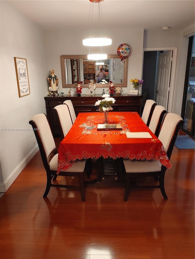 dining space with dark wood-type flooring